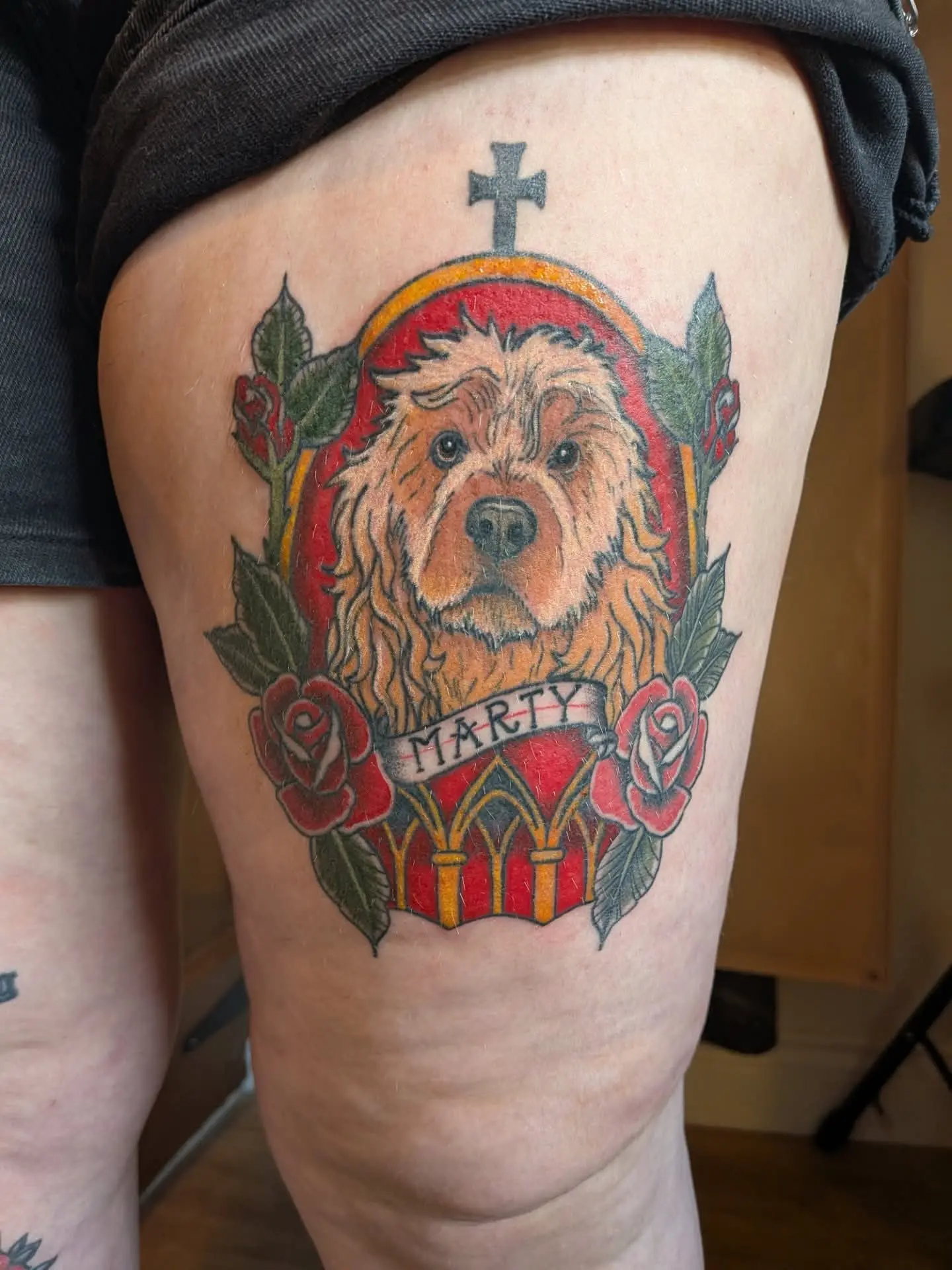 Traditional-style memorial portrait of a dog named Marty, framed with roses